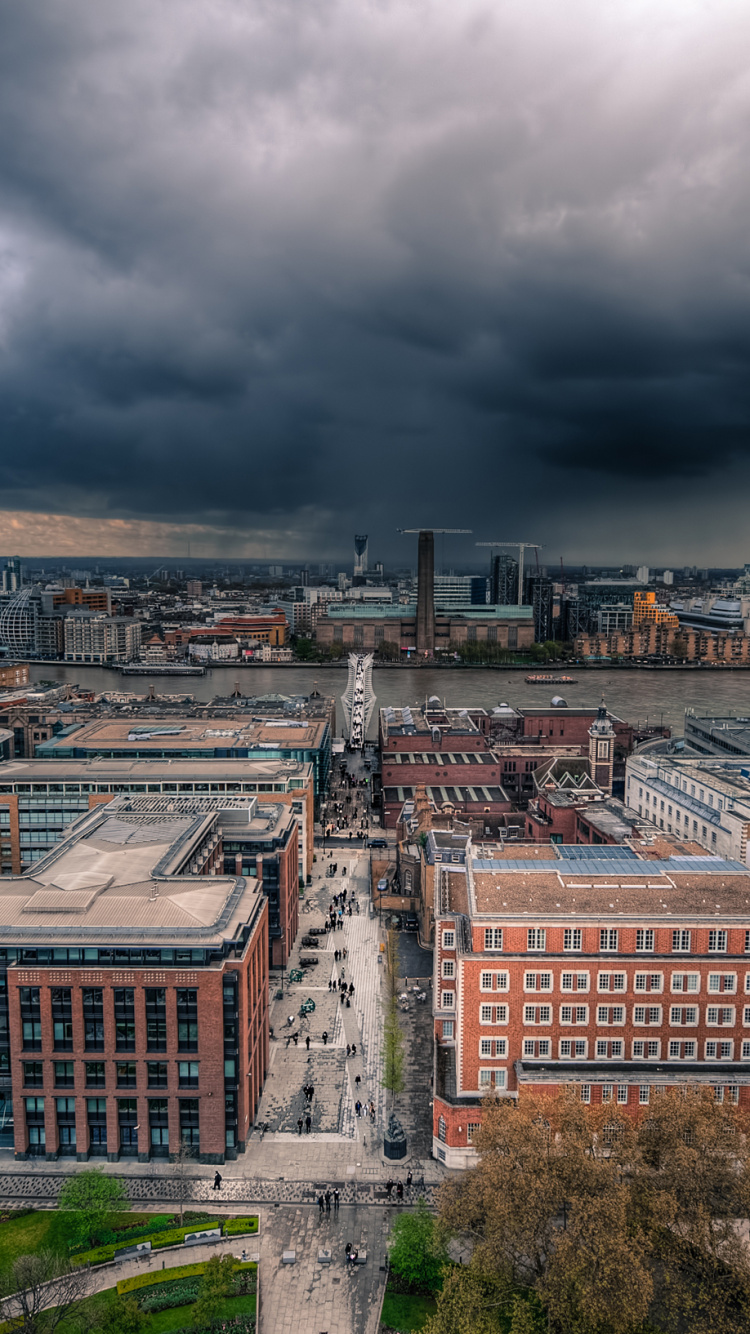 Brown and Gray Concrete Building Under Gray Clouds. Wallpaper in 750x1334 Resolution