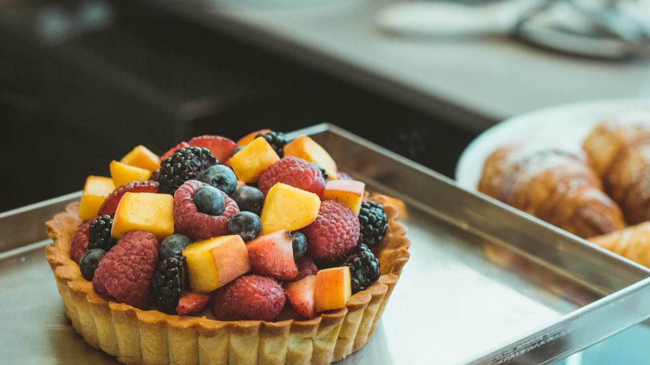 Brown Cupcake With Assorted Fruits on Top. Wallpaper in 1280x720 Resolution