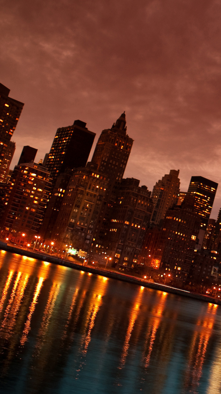 City Skyline Across Body of Water During Night Time. Wallpaper in 750x1334 Resolution