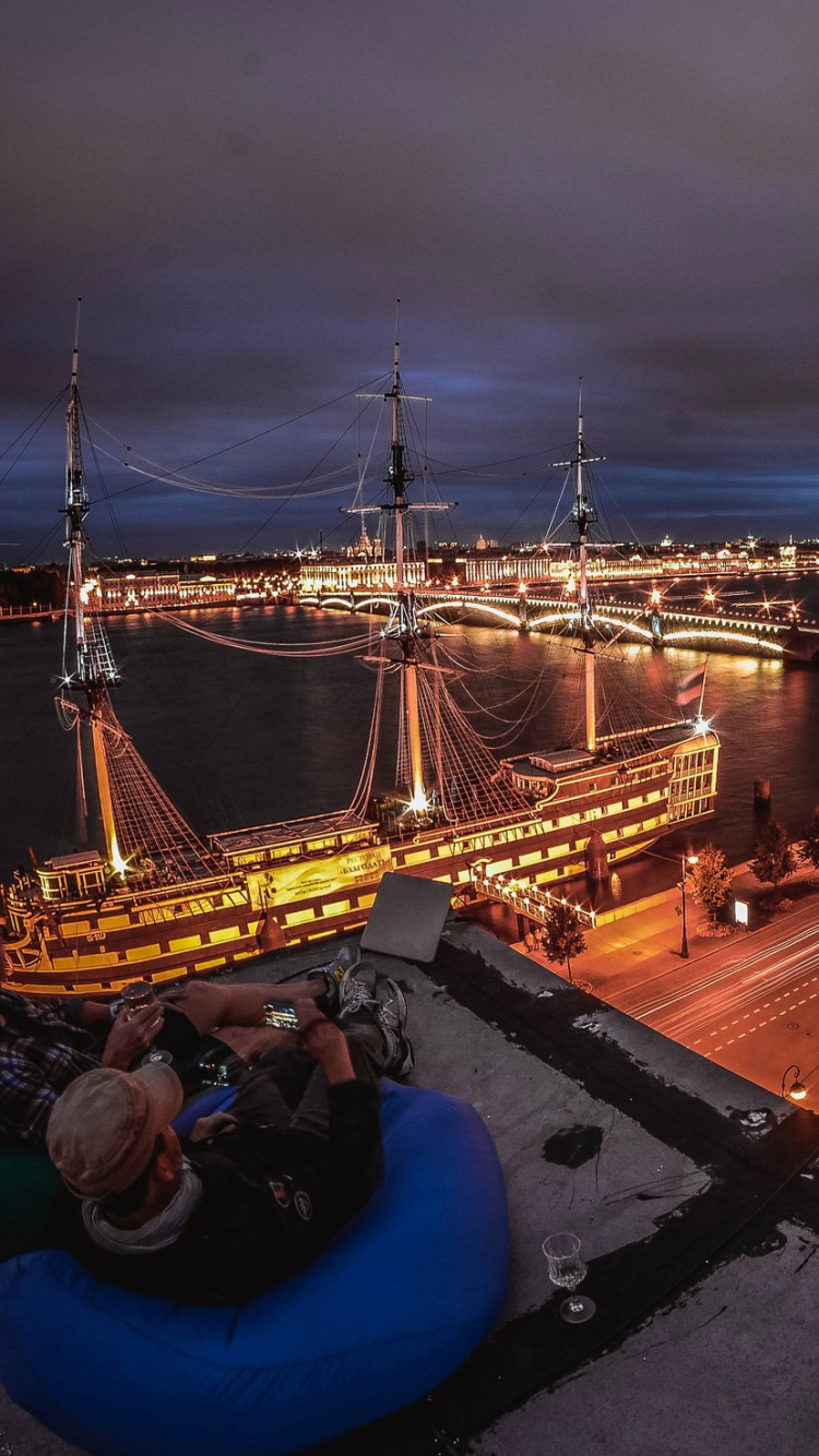 Man in Blue Shirt Sitting on Blue Chair. Wallpaper in 750x1334 Resolution