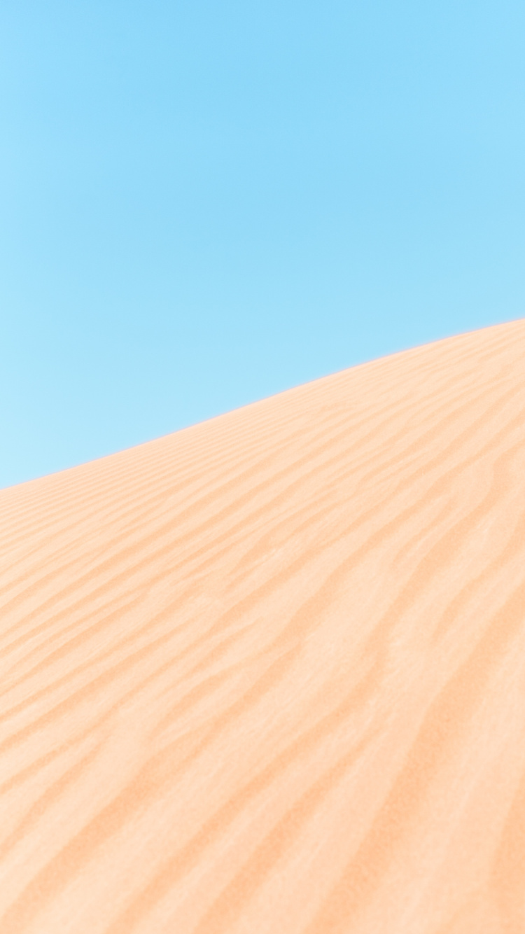 Brown Sand Under Blue Sky During Daytime. Wallpaper in 750x1334 Resolution