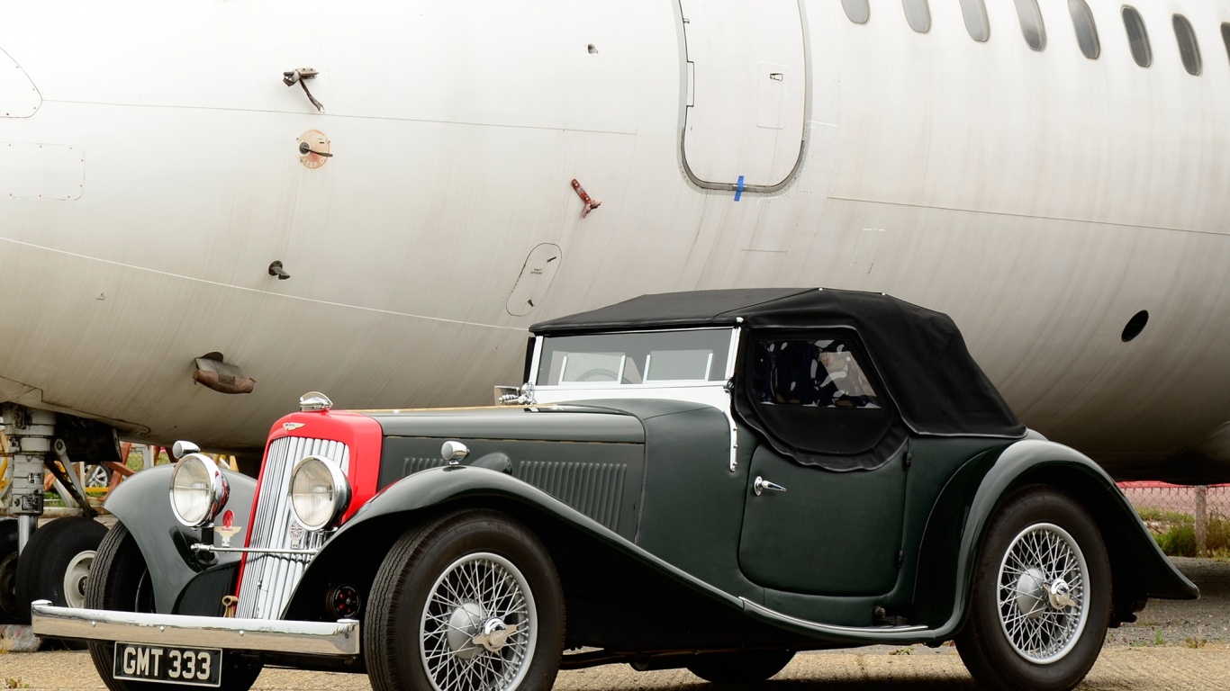 Vintage Black Car Parked Beside White Airplane. Wallpaper in 1366x768 Resolution
