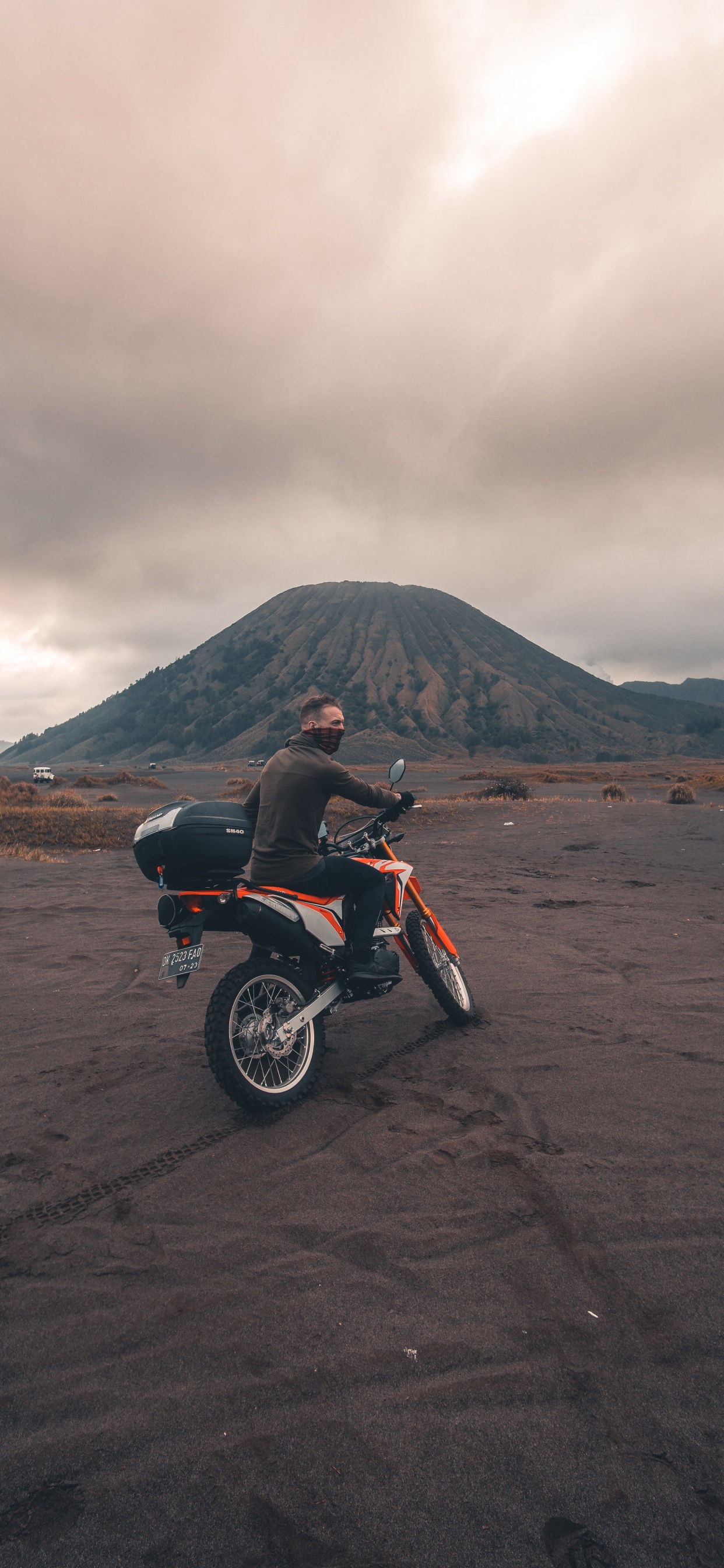 Red and Black Motorcycle on Brown Sand Under Cloudy Sky During Daytime. Wallpaper in 1242x2688 Resolution