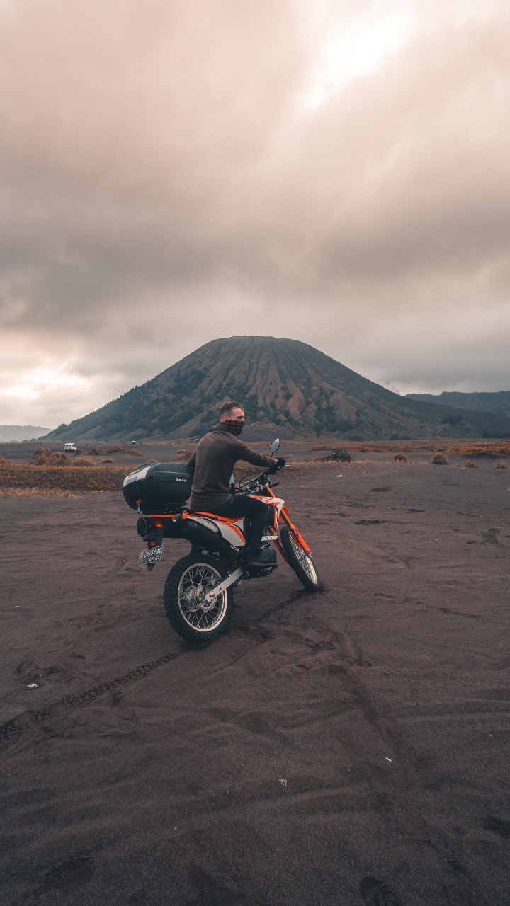 Red and Black Motorcycle on Brown Sand Under Cloudy Sky During Daytime. Wallpaper in 720x1280 Resolution