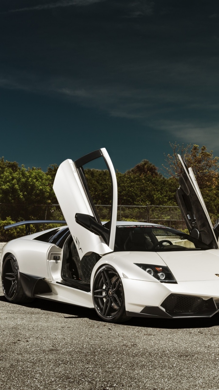 White and Black Sports Car Parked Near White Concrete Building During Daytime. Wallpaper in 720x1280 Resolution