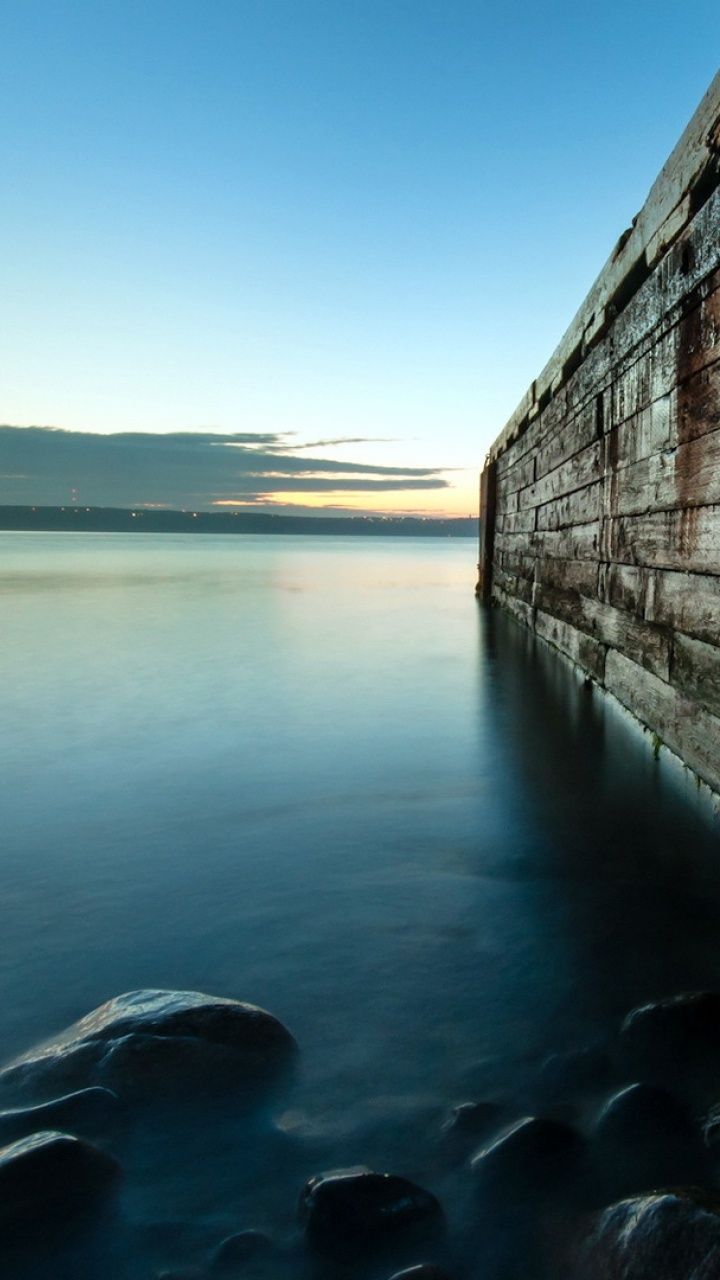 Brown Wooden Dock on Body of Water During Daytime. Wallpaper in 720x1280 Resolution