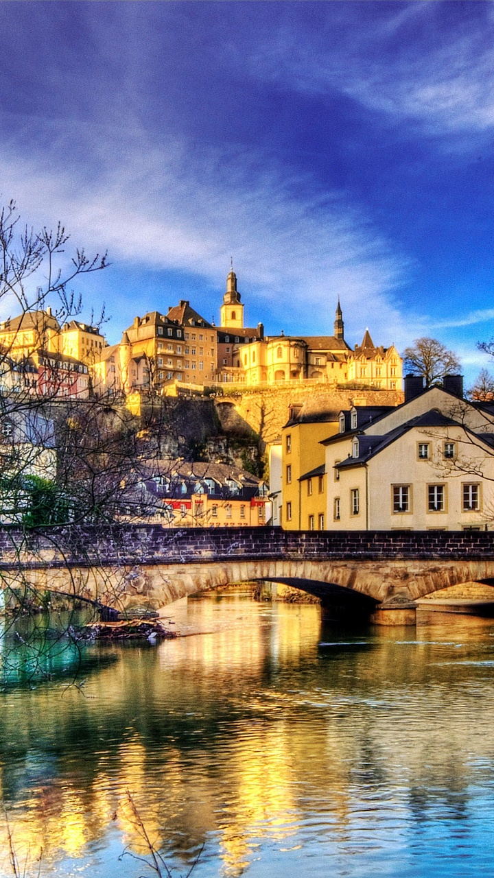 Brown Concrete Building Near Body of Water Under Blue Sky During Daytime. Wallpaper in 720x1280 Resolution
