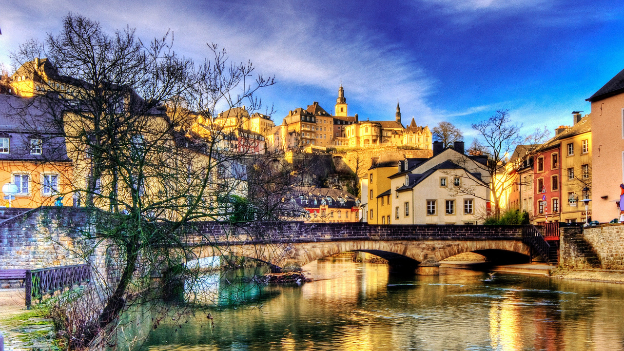 Bâtiment en Béton Brun Près D'un Plan D'eau Sous un Ciel Bleu Pendant la Journée. Wallpaper in 1280x720 Resolution