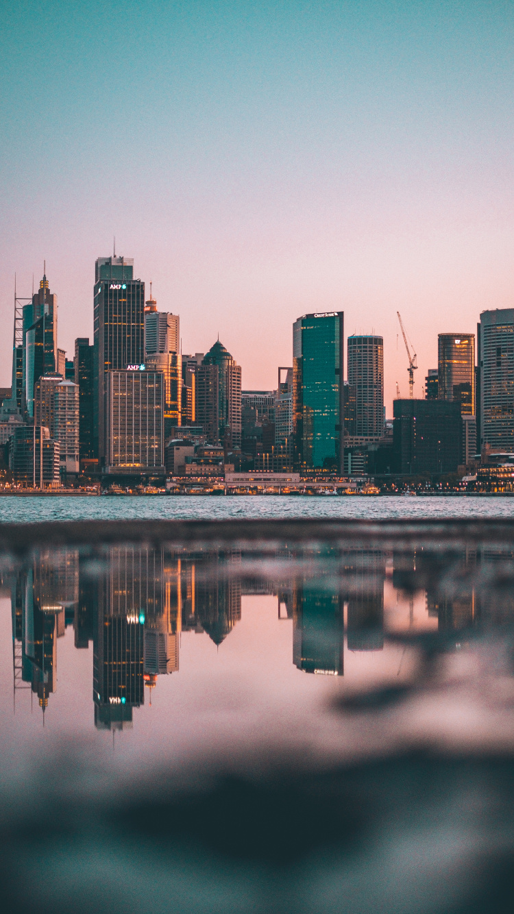 City Skyline Across Body of Water During Night Time. Wallpaper in 750x1334 Resolution