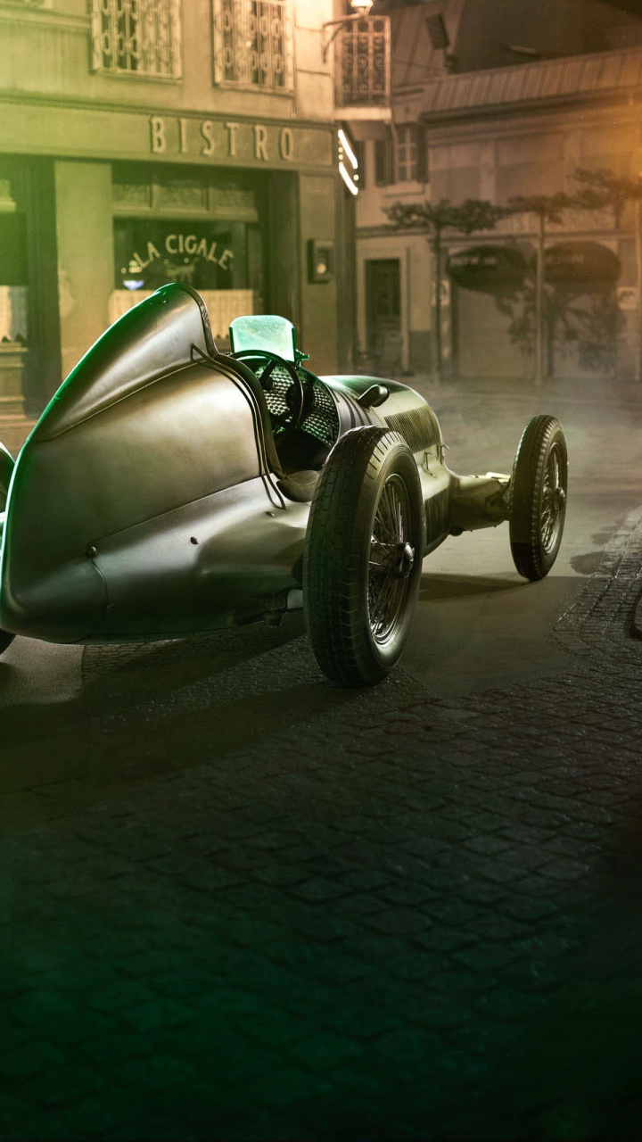 Moto Verte et Noire Garée à Côté du Bâtiment Pendant la Nuit. Wallpaper in 720x1280 Resolution