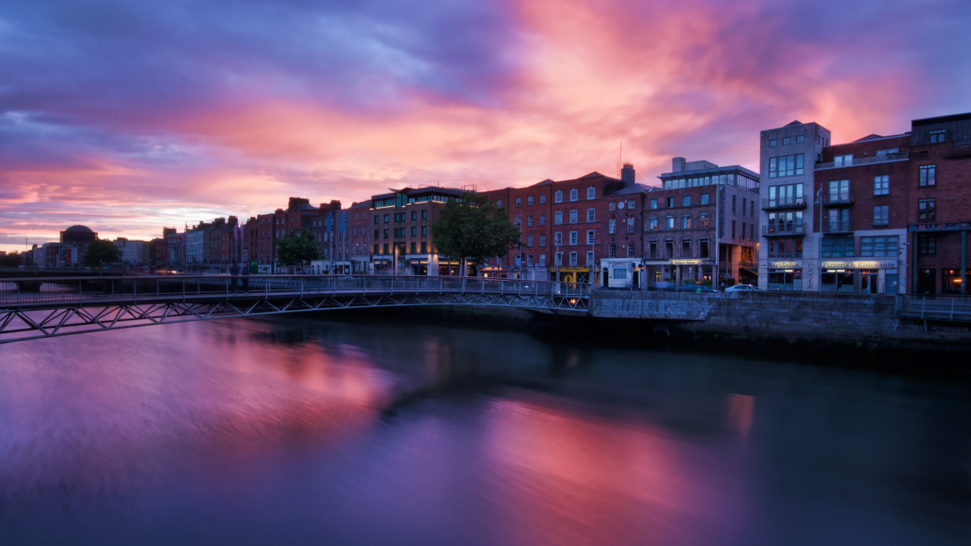 City Skyline Near Body of Water During Sunset. Wallpaper in 1366x768 Resolution