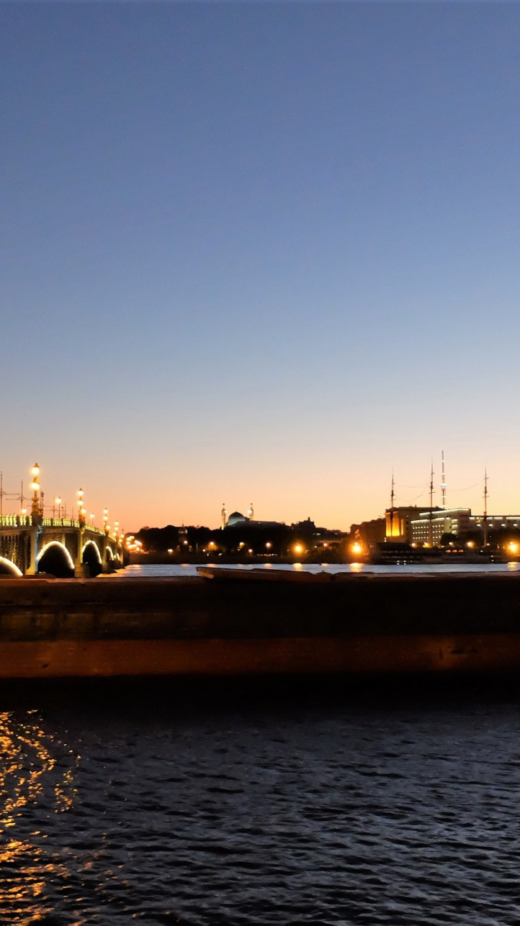 Body of Water Near City Buildings During Night Time. Wallpaper in 750x1334 Resolution