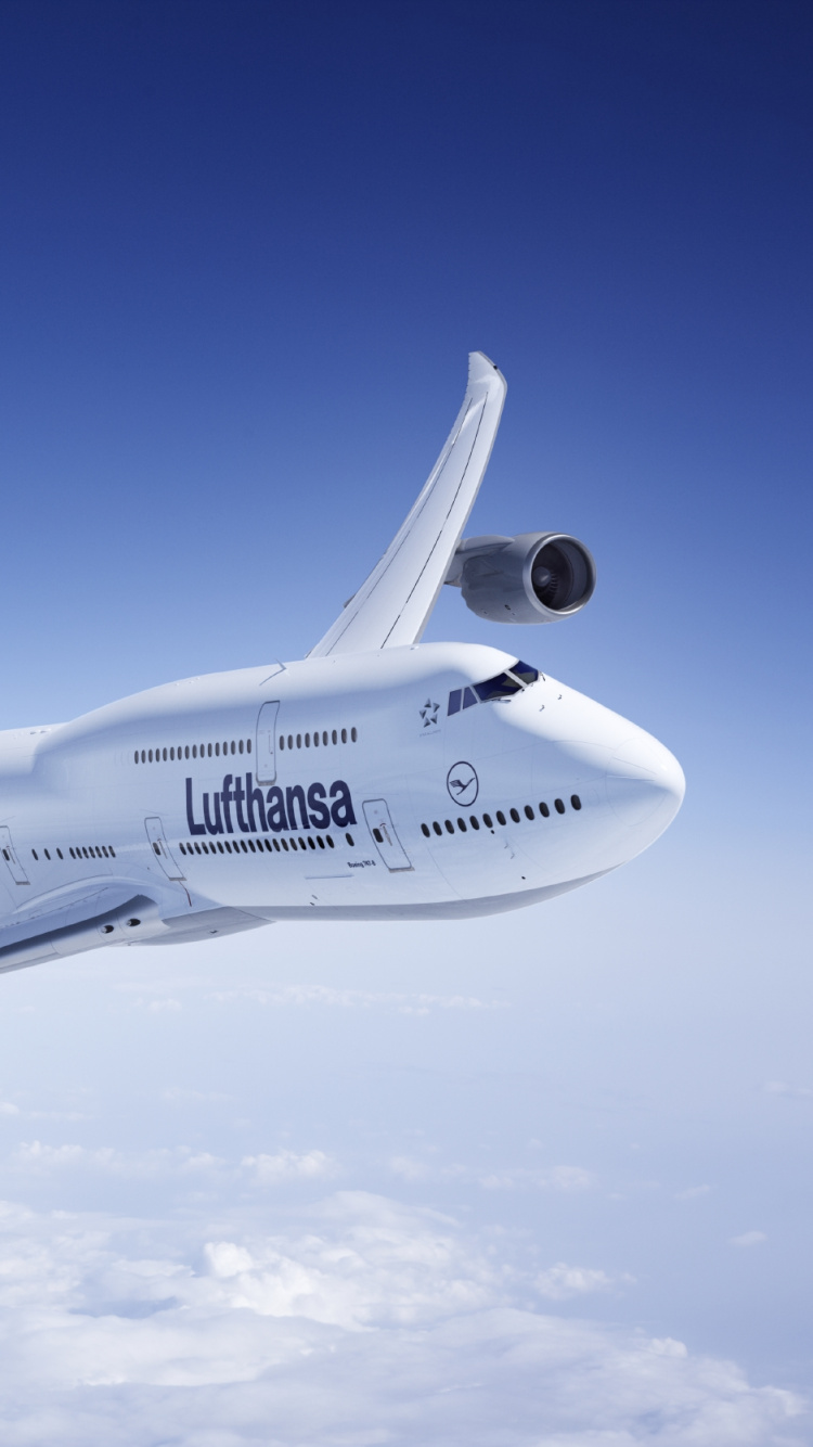 White and Blue Airplane Under Blue Sky During Daytime. Wallpaper in 750x1334 Resolution