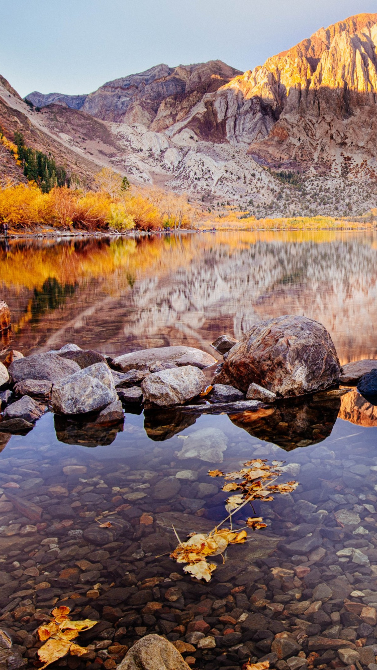 Brown Rocky Mountain Beside River During Daytime. Wallpaper in 750x1334 Resolution