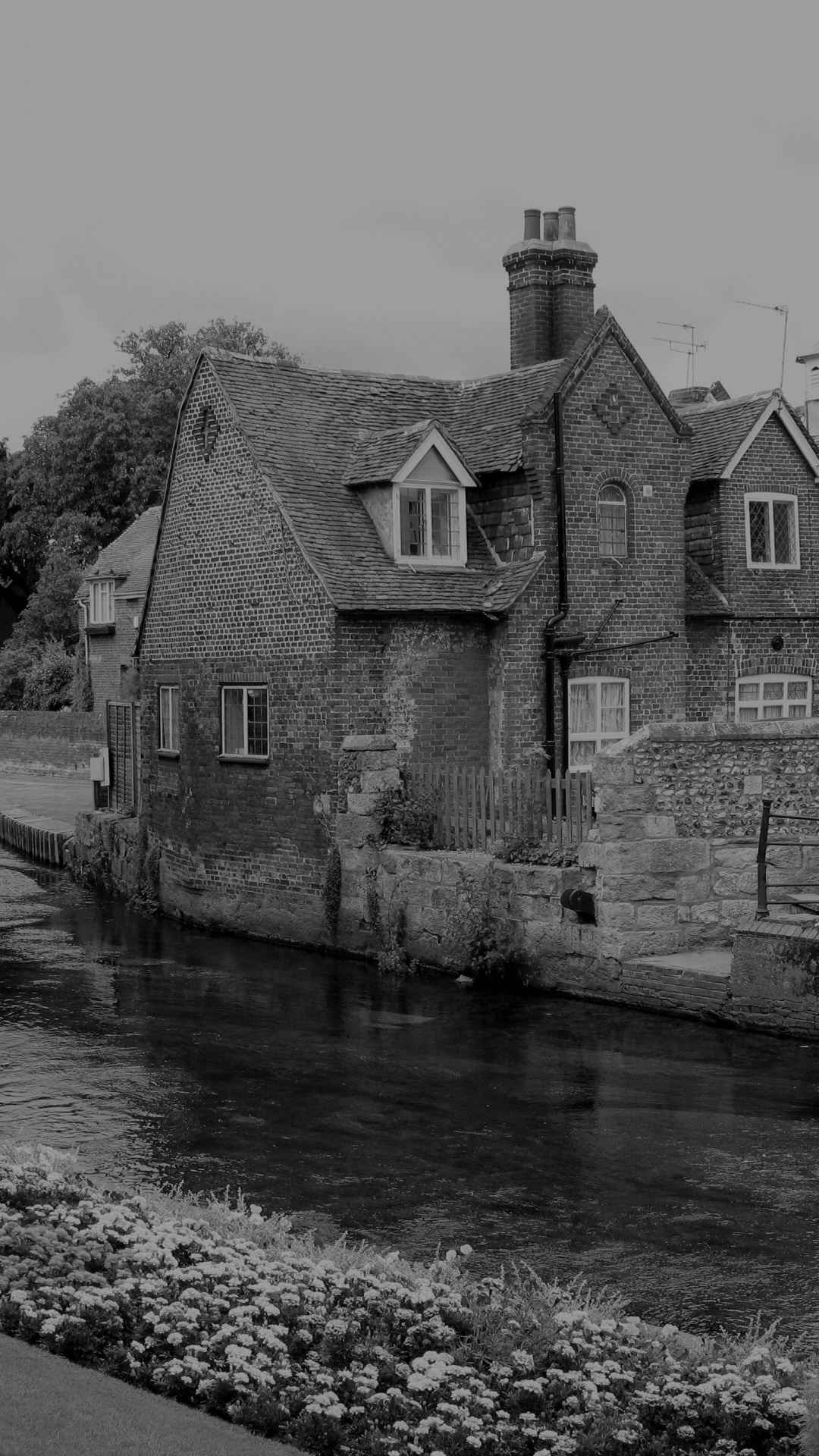 Grayscale Photo of Concrete House Near River. Wallpaper in 1080x1920 Resolution