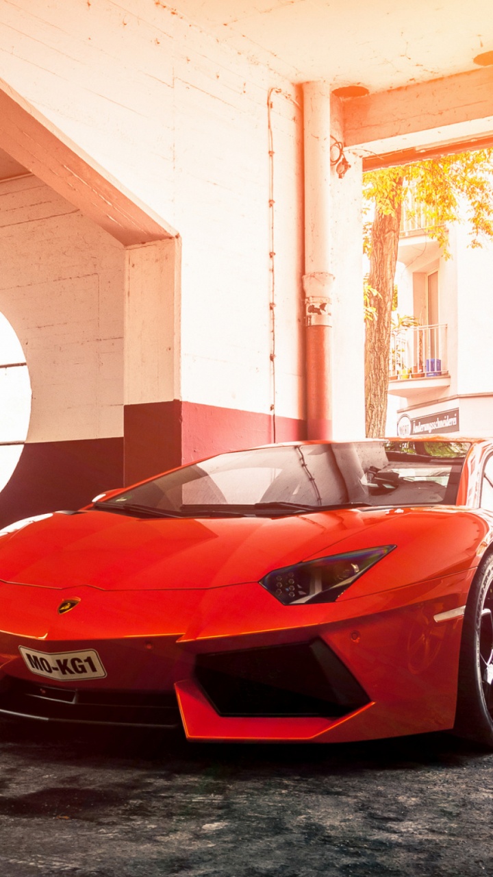 Red Ferrari Sports Car Parked in Garage. Wallpaper in 720x1280 Resolution