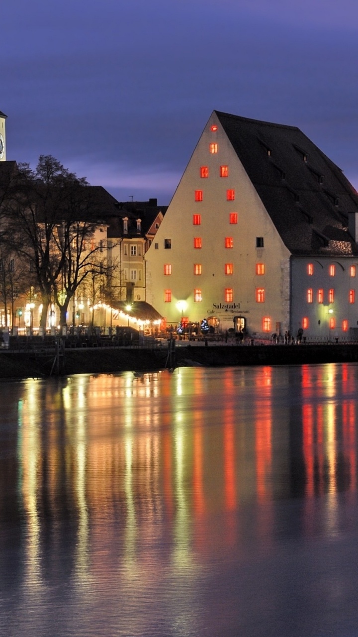 Brown and White Concrete Building Near Body of Water During Night Time. Wallpaper in 720x1280 Resolution
