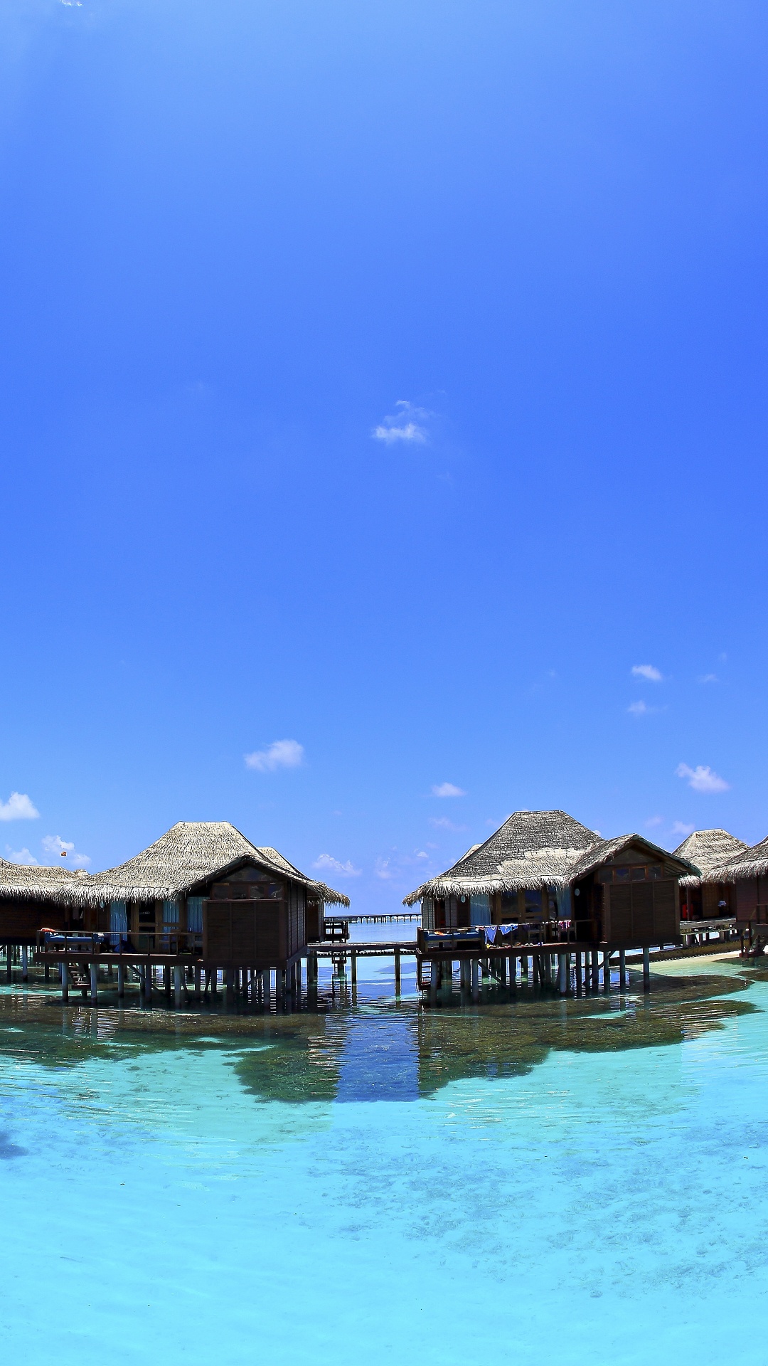 Brown Wooden Houses on Water Under Blue Sky During Daytime. Wallpaper in 1080x1920 Resolution