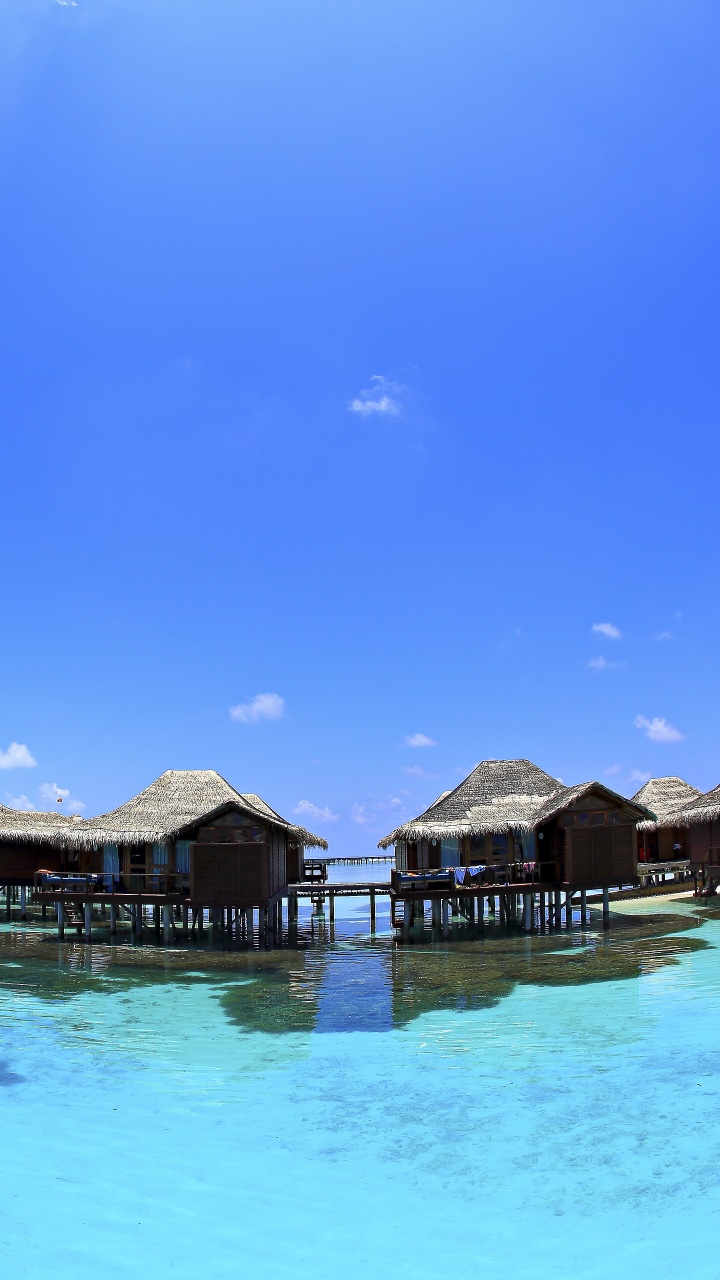 Brown Wooden Houses on Water Under Blue Sky During Daytime. Wallpaper in 720x1280 Resolution
