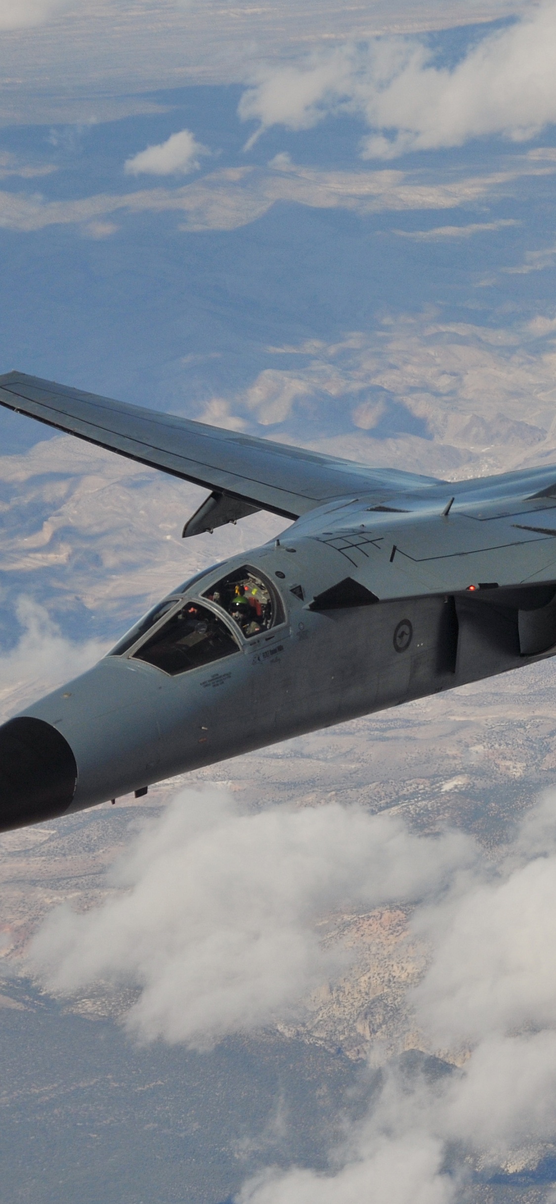 Black Fighter Jet Flying Over White Clouds During Daytime. Wallpaper in 1125x2436 Resolution