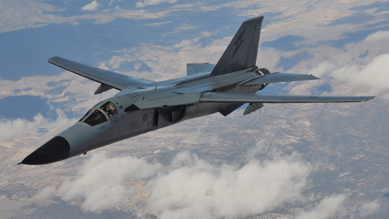 Black Fighter Jet Flying Over White Clouds During Daytime. Wallpaper in 1366x768 Resolution