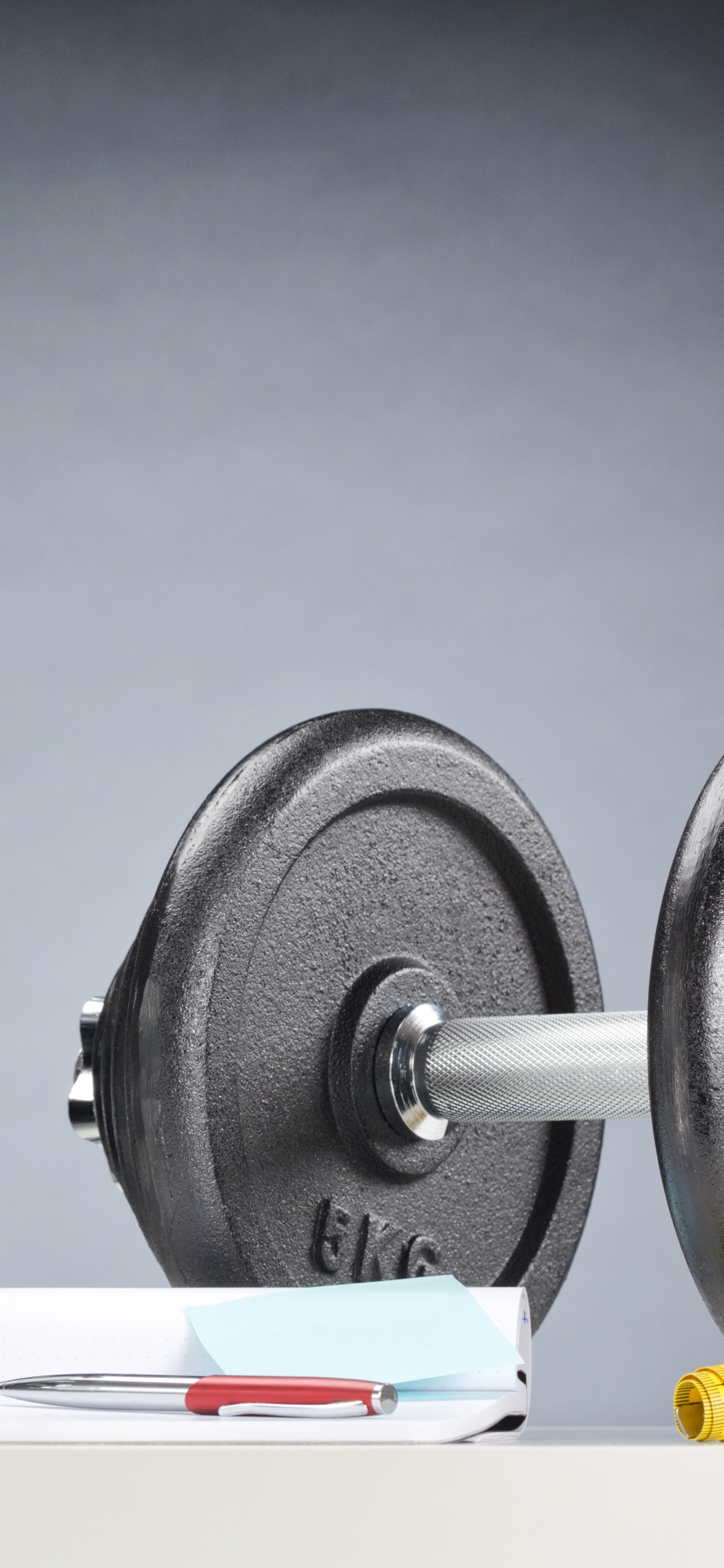 Black and White Dumbbells on White Table. Wallpaper in 1242x2688 Resolution