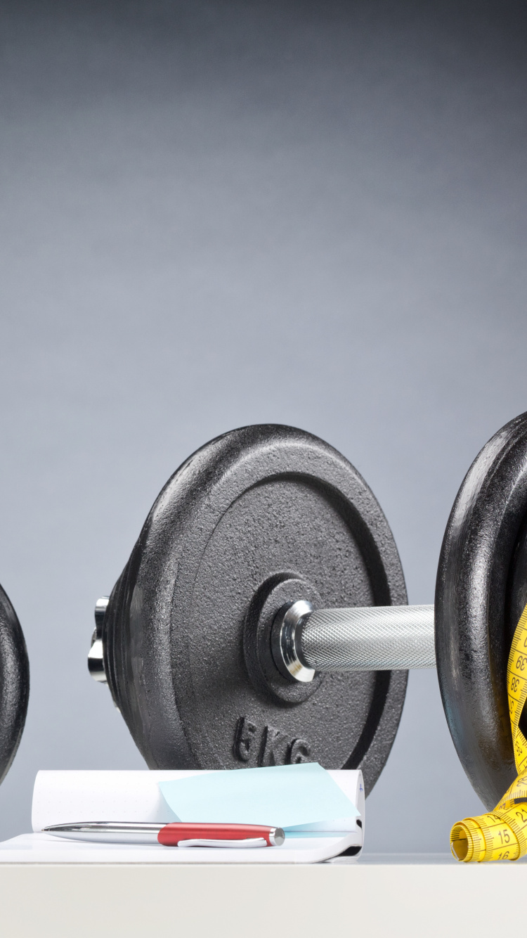 Black and White Dumbbells on White Table. Wallpaper in 750x1334 Resolution