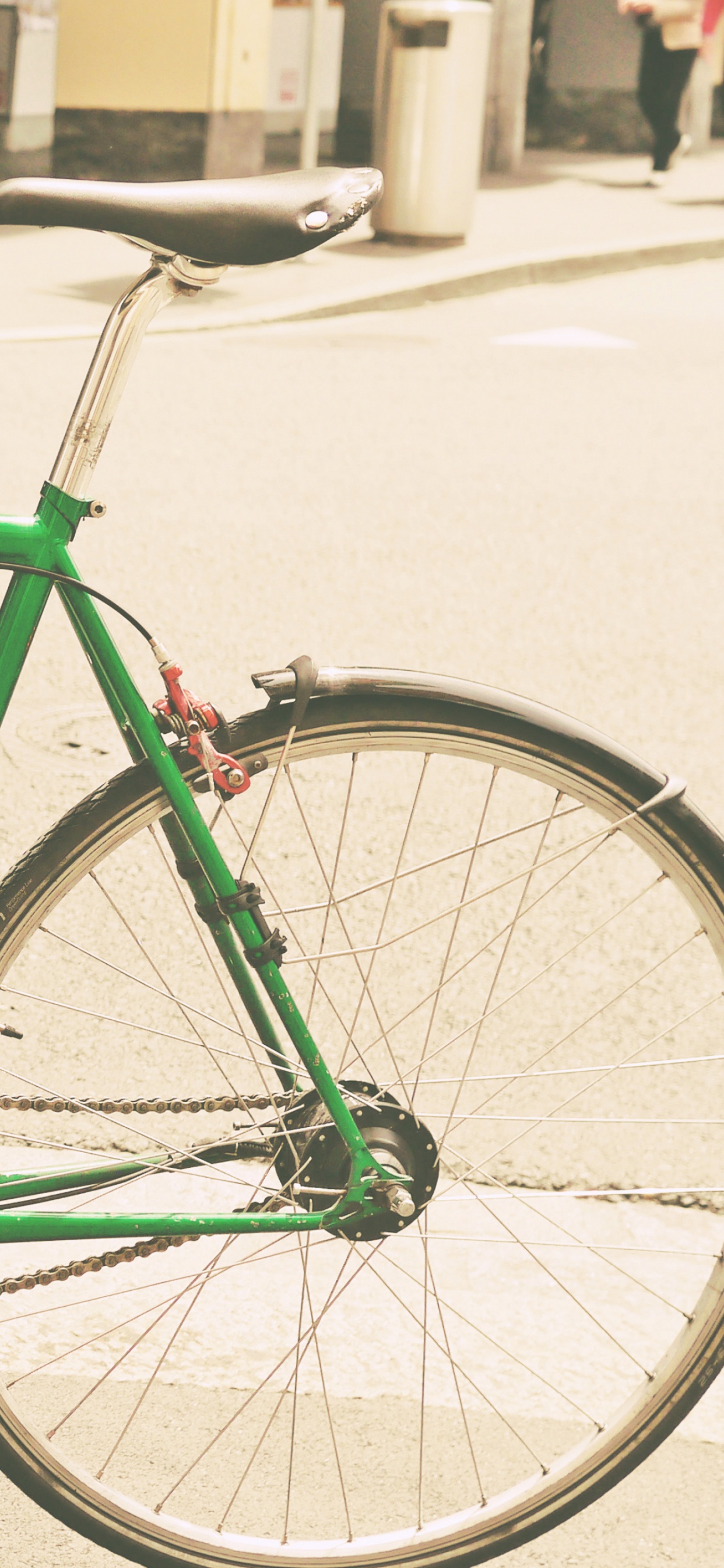 Green Bicycle Parked on Sidewalk During Daytime. Wallpaper in 1242x2688 Resolution