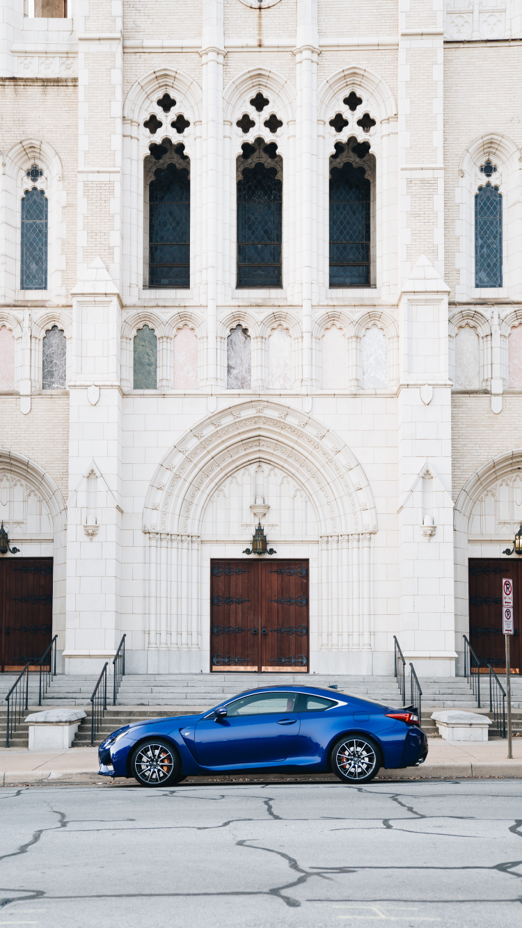 Blue Coupe Parked Beside White Concrete Building During Daytime. Wallpaper in 750x1334 Resolution