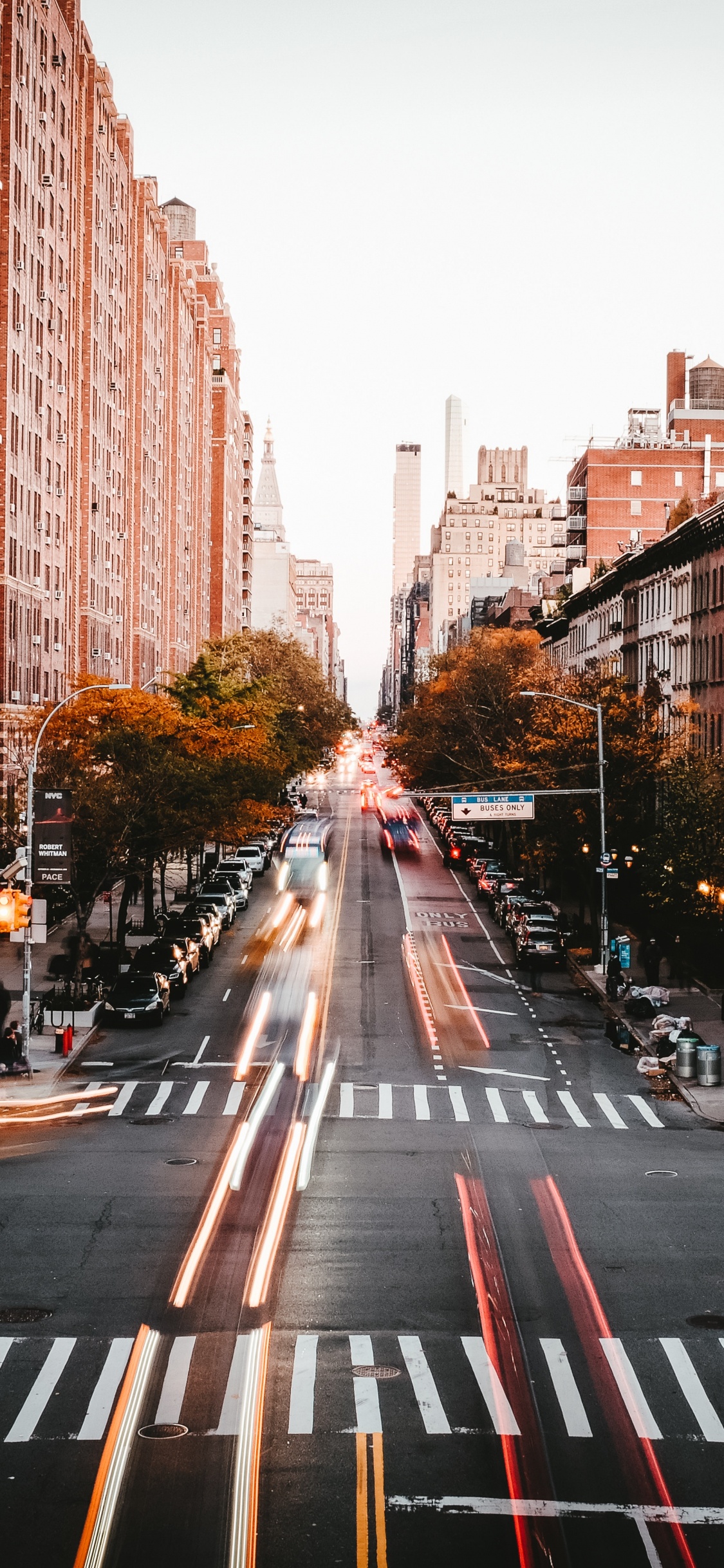 Cars on Road Between High Rise Buildings During Daytime. Wallpaper in 1125x2436 Resolution