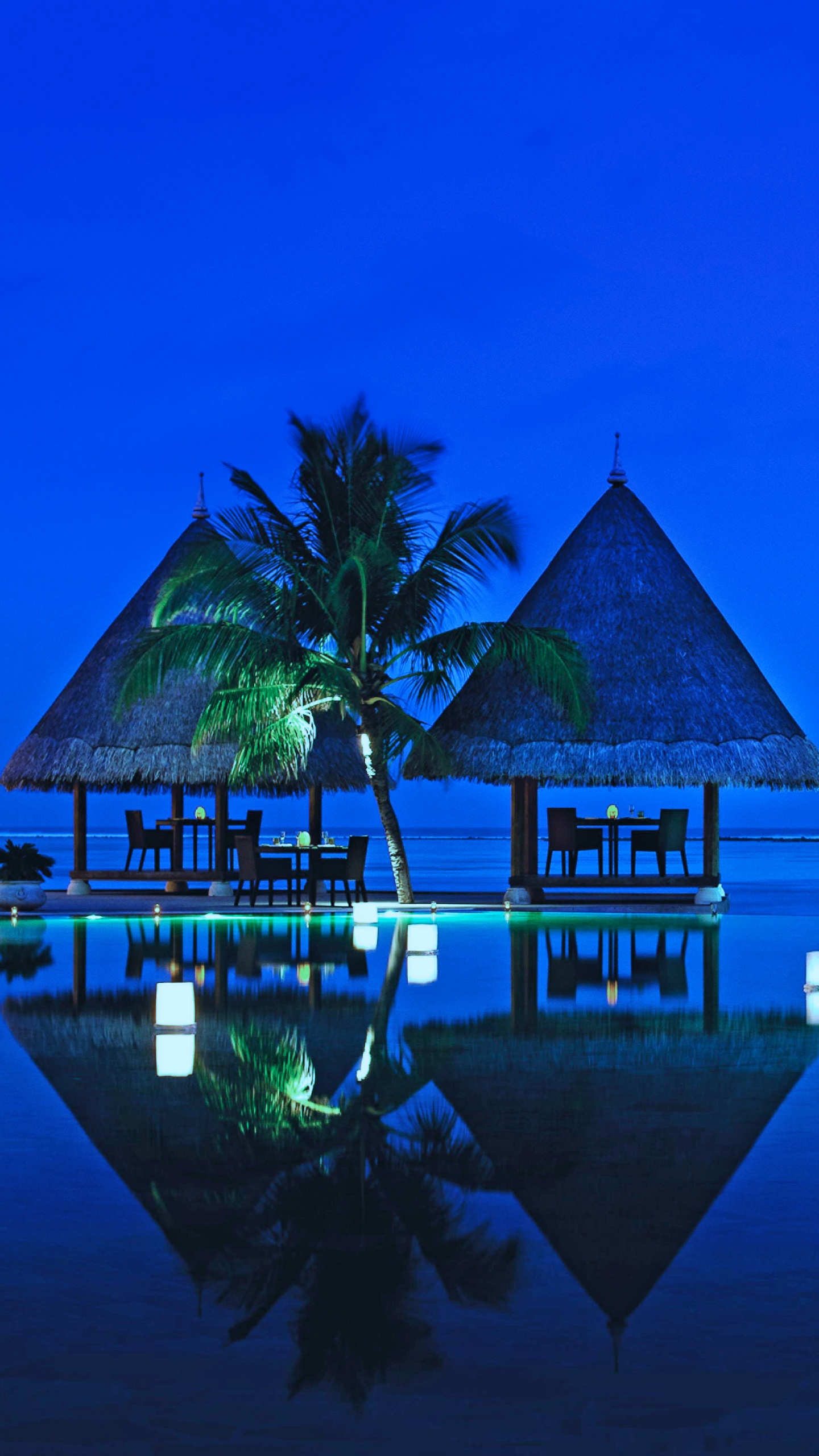 Brown Wooden House on Body of Water During Night Time. Wallpaper in 1440x2560 Resolution