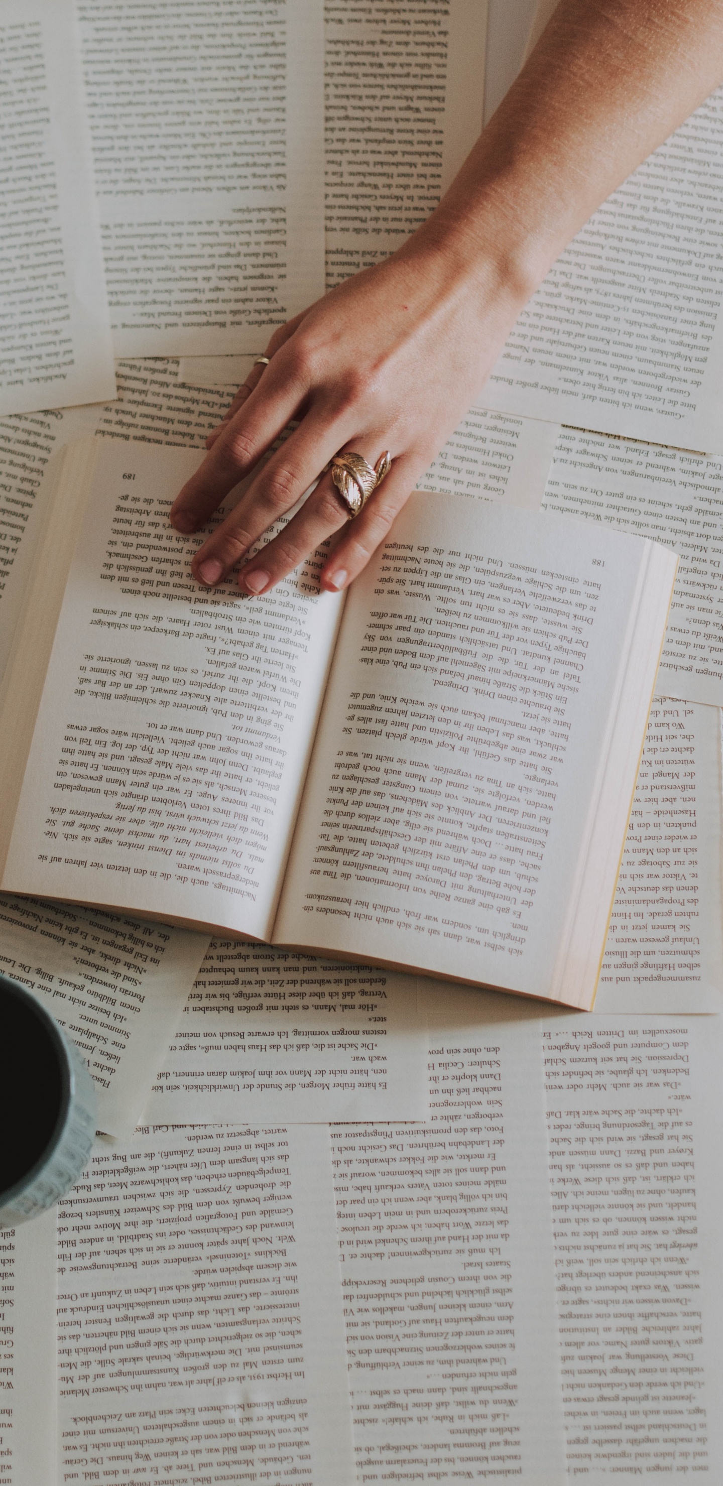 Person Holding White Ceramic Mug on White Book Page. Wallpaper in 1440x2960 Resolution