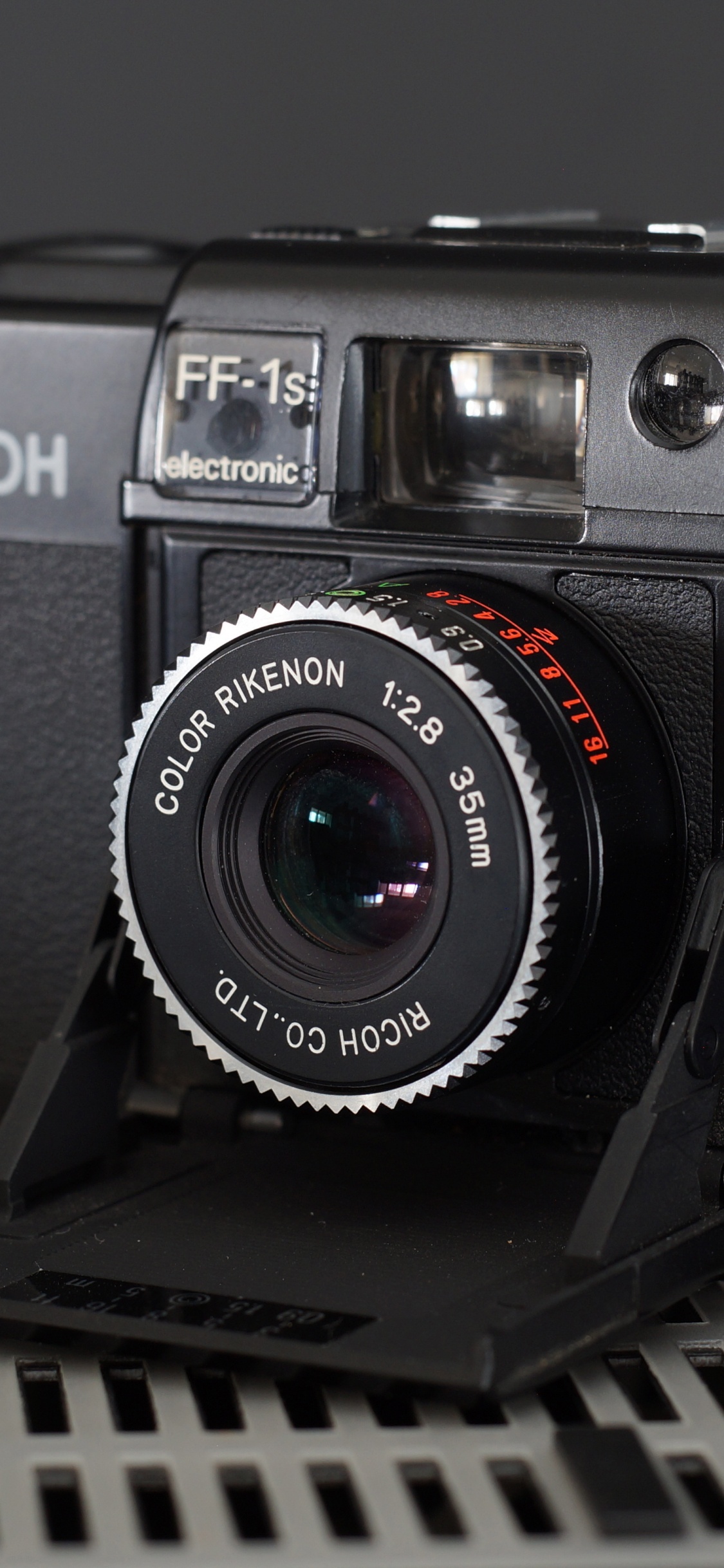 Black Nikon Dslr Camera on Black Metal Frame. Wallpaper in 1125x2436 Resolution
