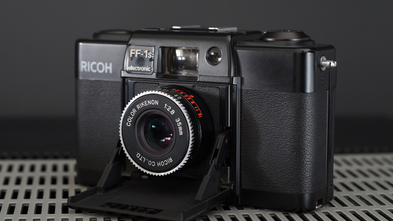 Black Nikon Dslr Camera on Black Metal Frame. Wallpaper in 1366x768 Resolution