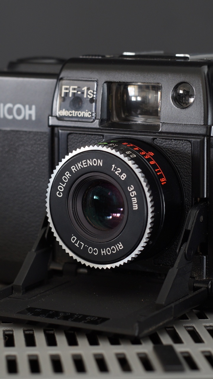 Black Nikon Dslr Camera on Black Metal Frame. Wallpaper in 720x1280 Resolution