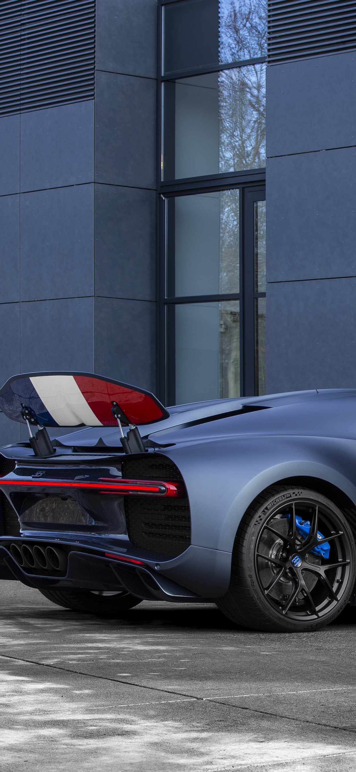 Red Ferrari 458 Italia Parked Near Building. Wallpaper in 1242x2688 Resolution