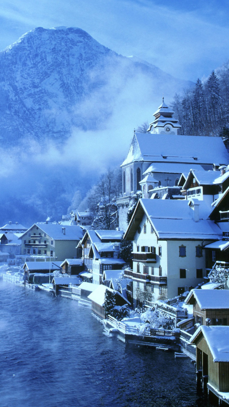 White and Brown Concrete Houses Near Body of Water During Daytime. Wallpaper in 750x1334 Resolution