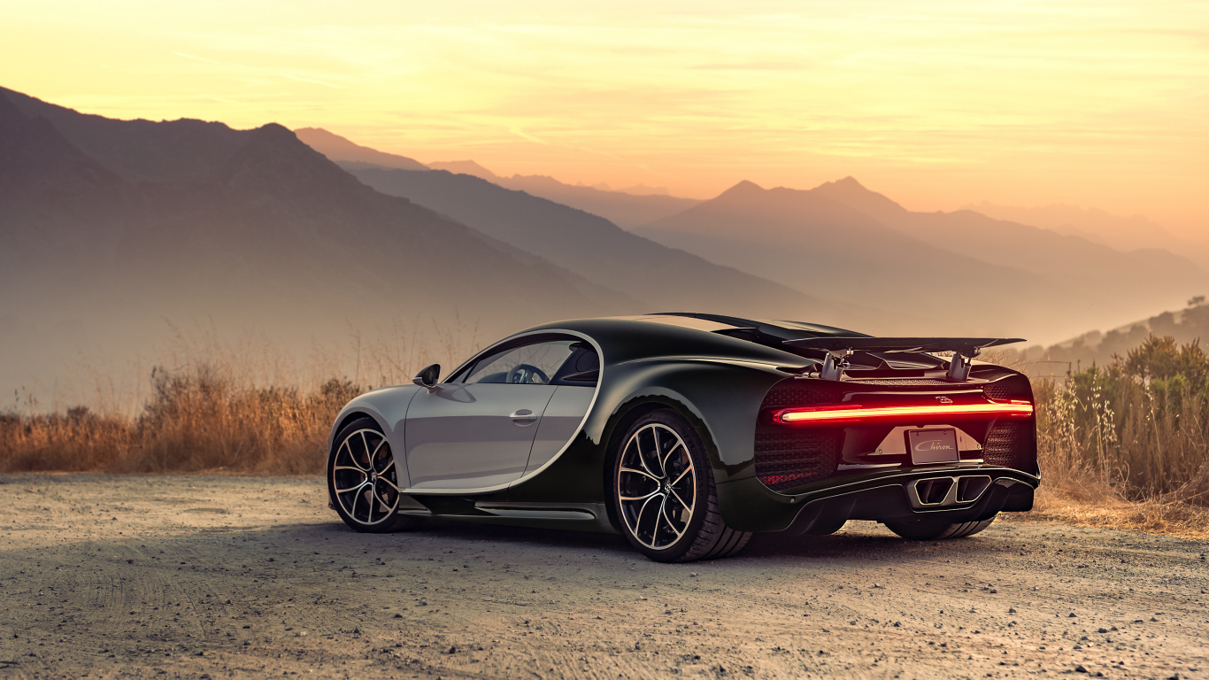 Schwarz-roter Ferrari-Sportwagen Auf Braunem Feld Tagsüber. Wallpaper in 1366x768 Resolution