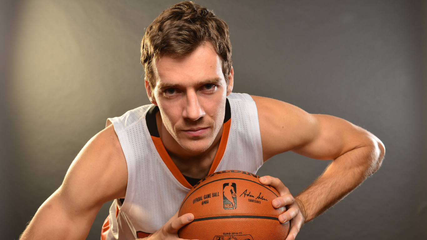 Man in White Tank Top Holding Brown Basketball. Wallpaper in 1366x768 Resolution