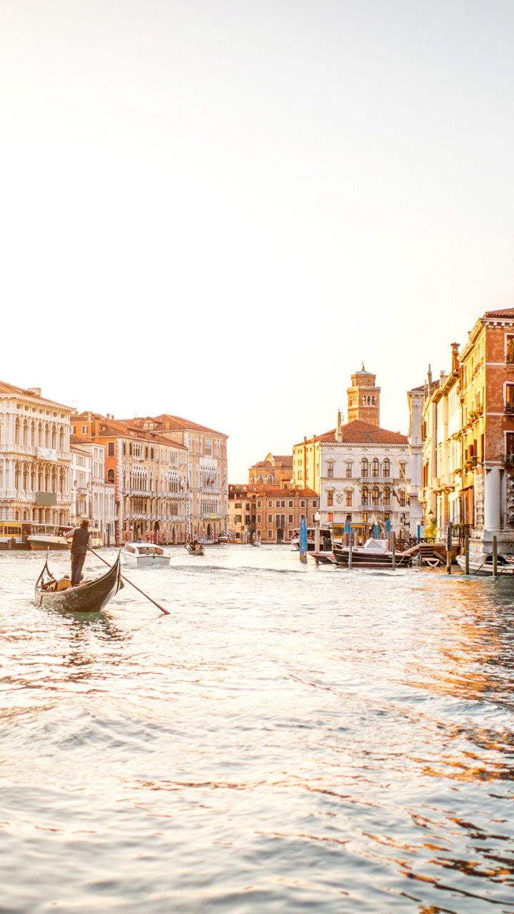Man Riding on Boat on Water Near Buildings During Daytime. Wallpaper in 720x1280 Resolution