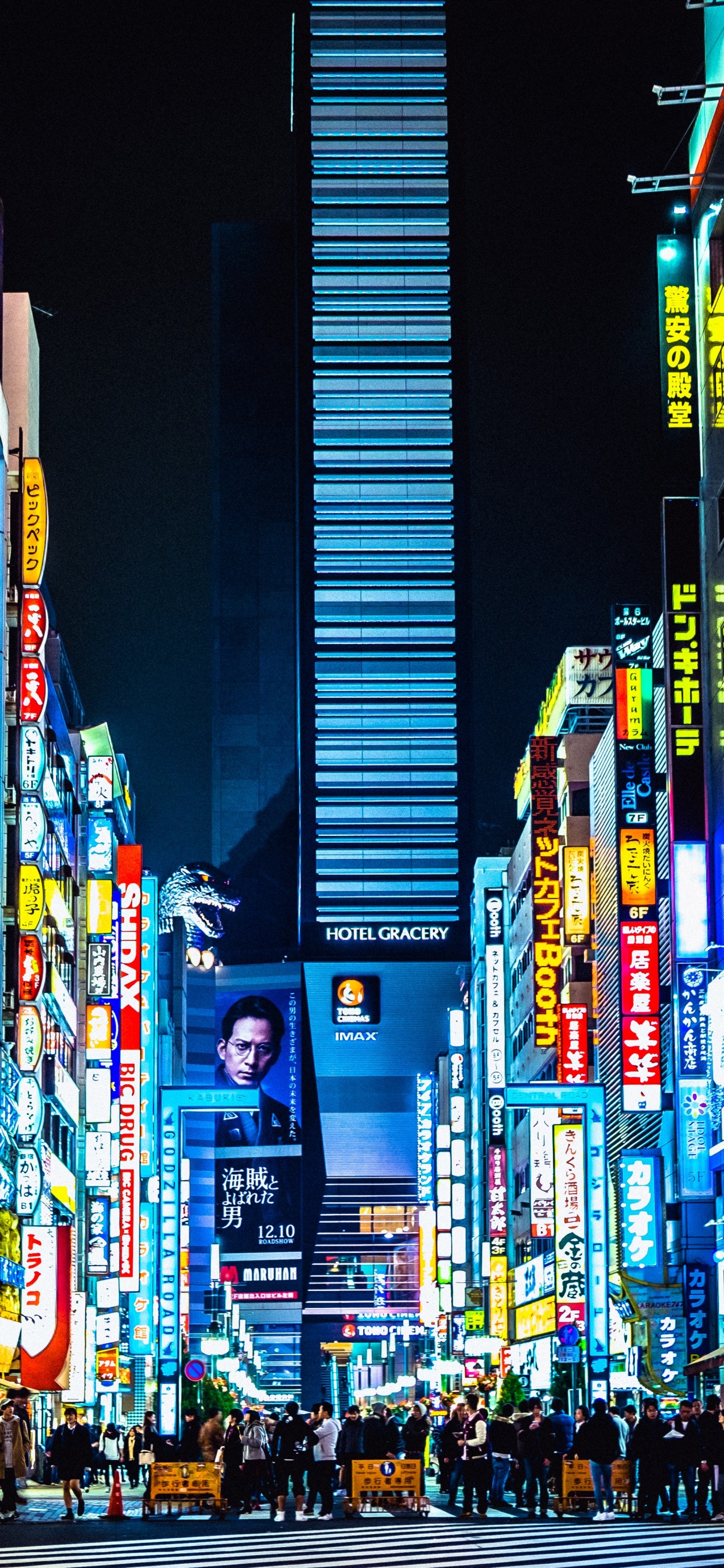 Man in Black Jacket Standing on Street During Nighttime. Wallpaper in 1242x2688 Resolution