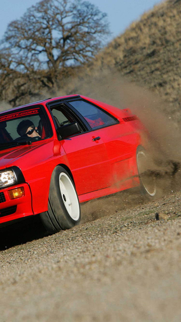 Audi Rouge a 4 Sur Route Pendant la Journée. Wallpaper in 750x1334 Resolution