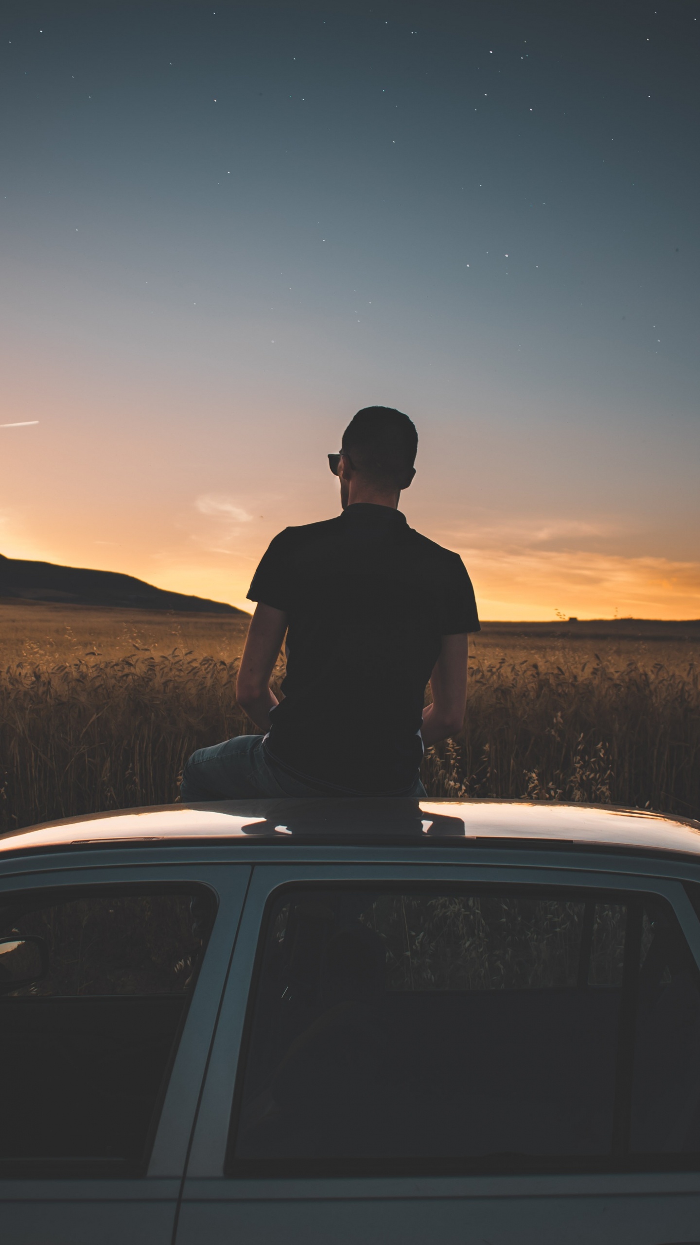 Silhouette of Man Standing on Car During Night Time. Wallpaper in 1440x2560 Resolution