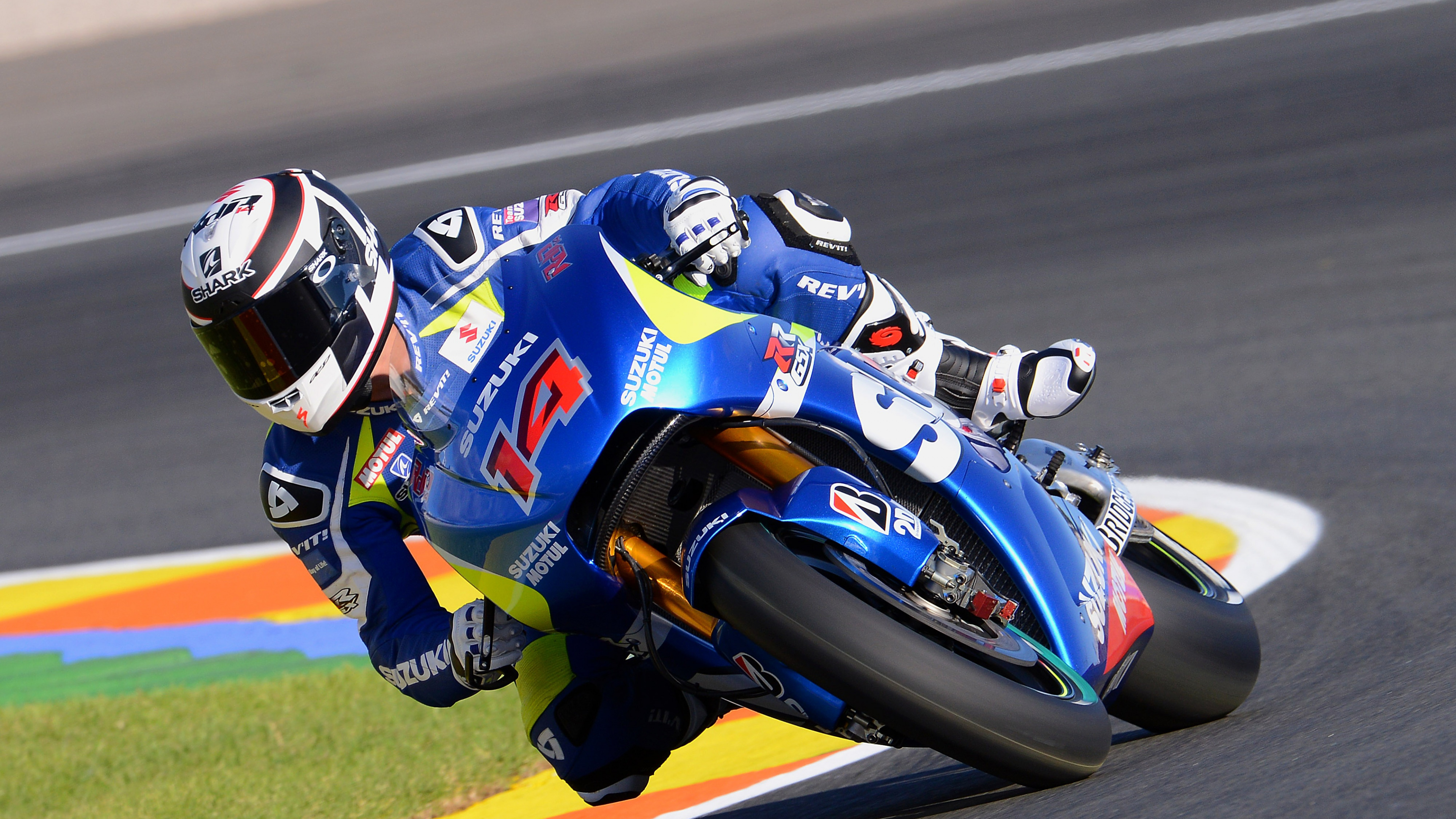 Man in Red and White Racing Suit Riding on Blue and Red Sports Bike. Wallpaper in 3840x2160 Resolution
