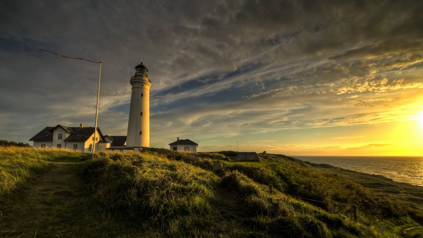 White Lighthouse on Green Grass Field Under Blue Sky During Daytime. Wallpaper in 1366x768 Resolution