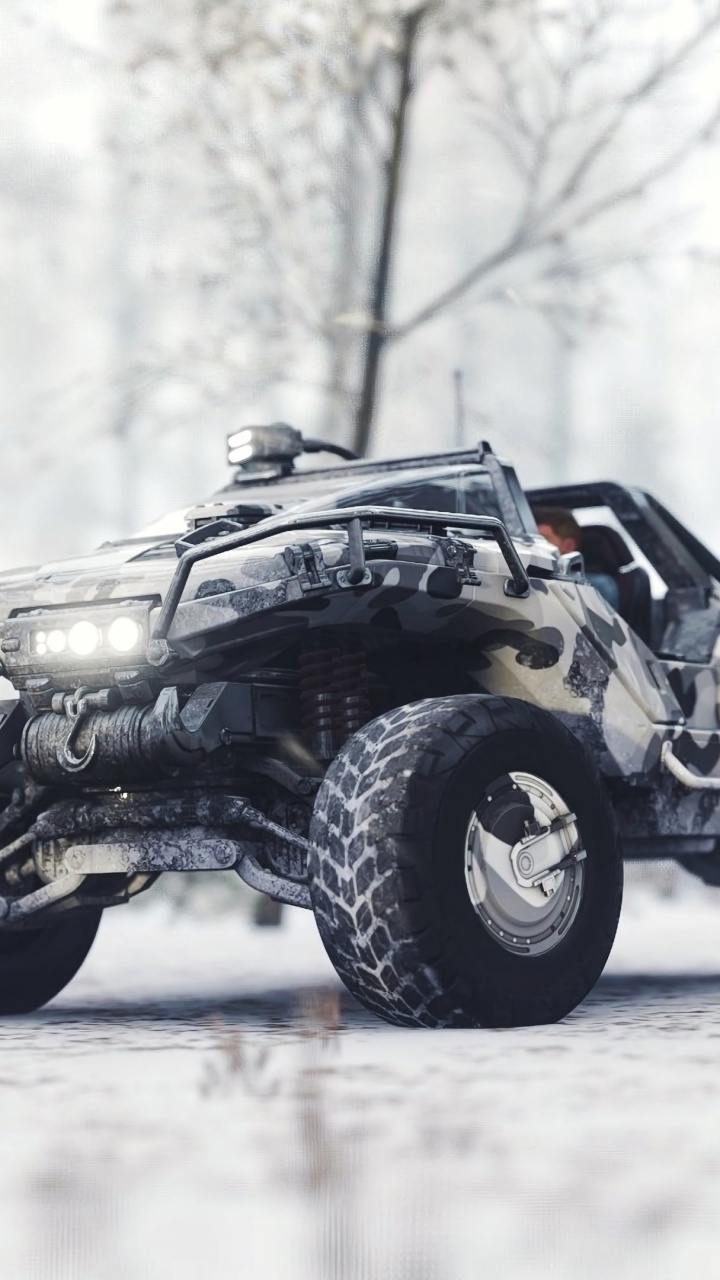 Schwarz-grauer ATV Auf Schneebedecktem Boden Tagsüber During. Wallpaper in 720x1280 Resolution