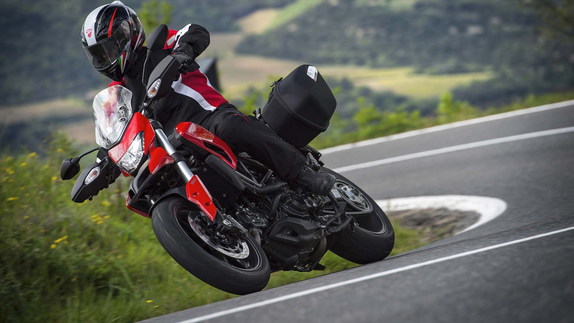 Man in Black and Red Motorcycle Suit Riding on Red Sports Bike on Road During Daytime. Wallpaper in 1920x1080 Resolution