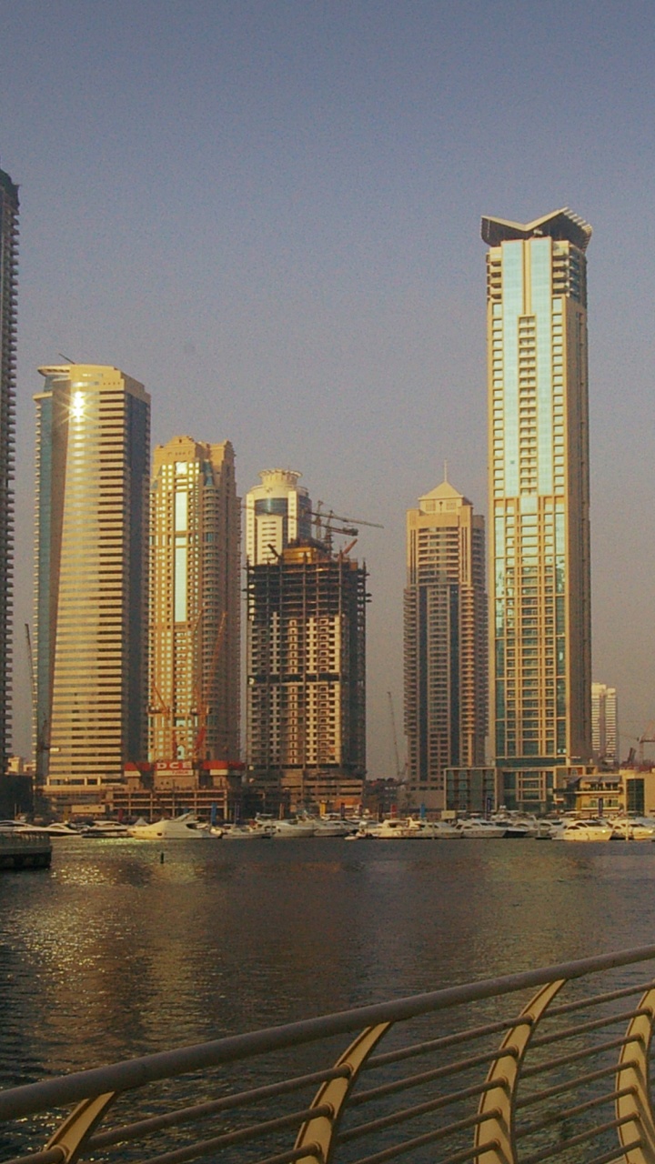 City Skyline Across Body of Water During Daytime. Wallpaper in 720x1280 Resolution