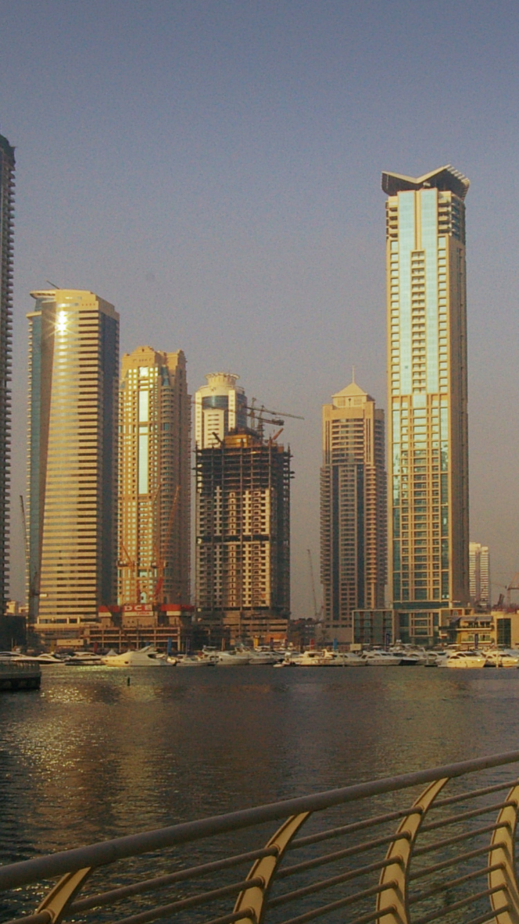 City Skyline Across Body of Water During Daytime. Wallpaper in 750x1334 Resolution