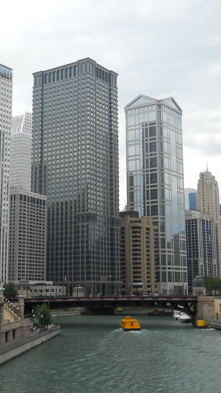 White and Gray Concrete Building Near Body of Water During Daytime. Wallpaper in 750x1334 Resolution